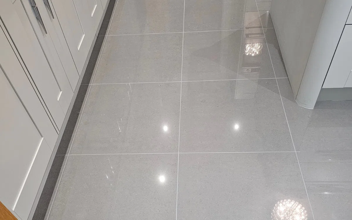 Specialist applying sealer to prepared tile grout lines