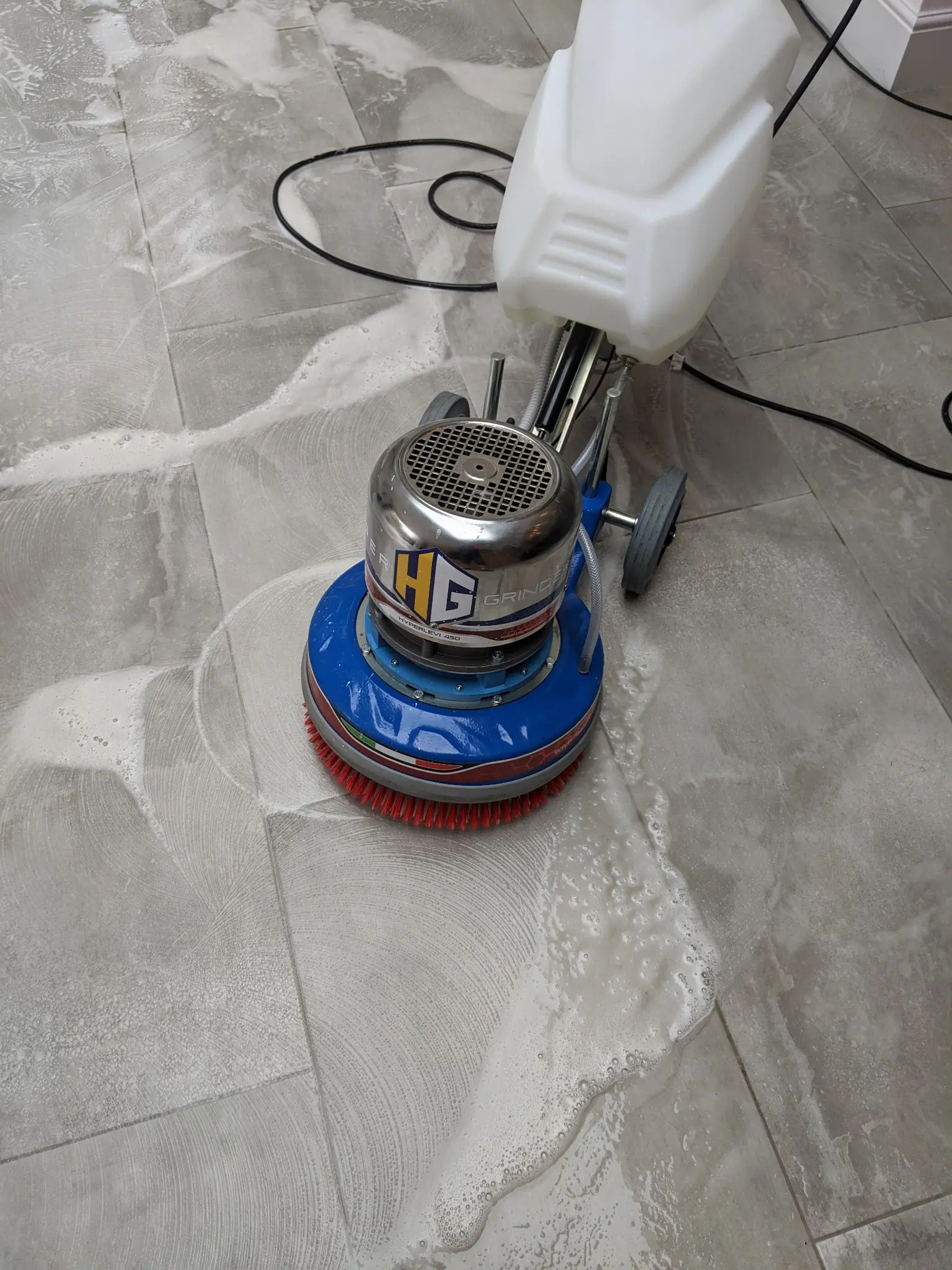 Professional cleaning of a tiled floor and grout lines
