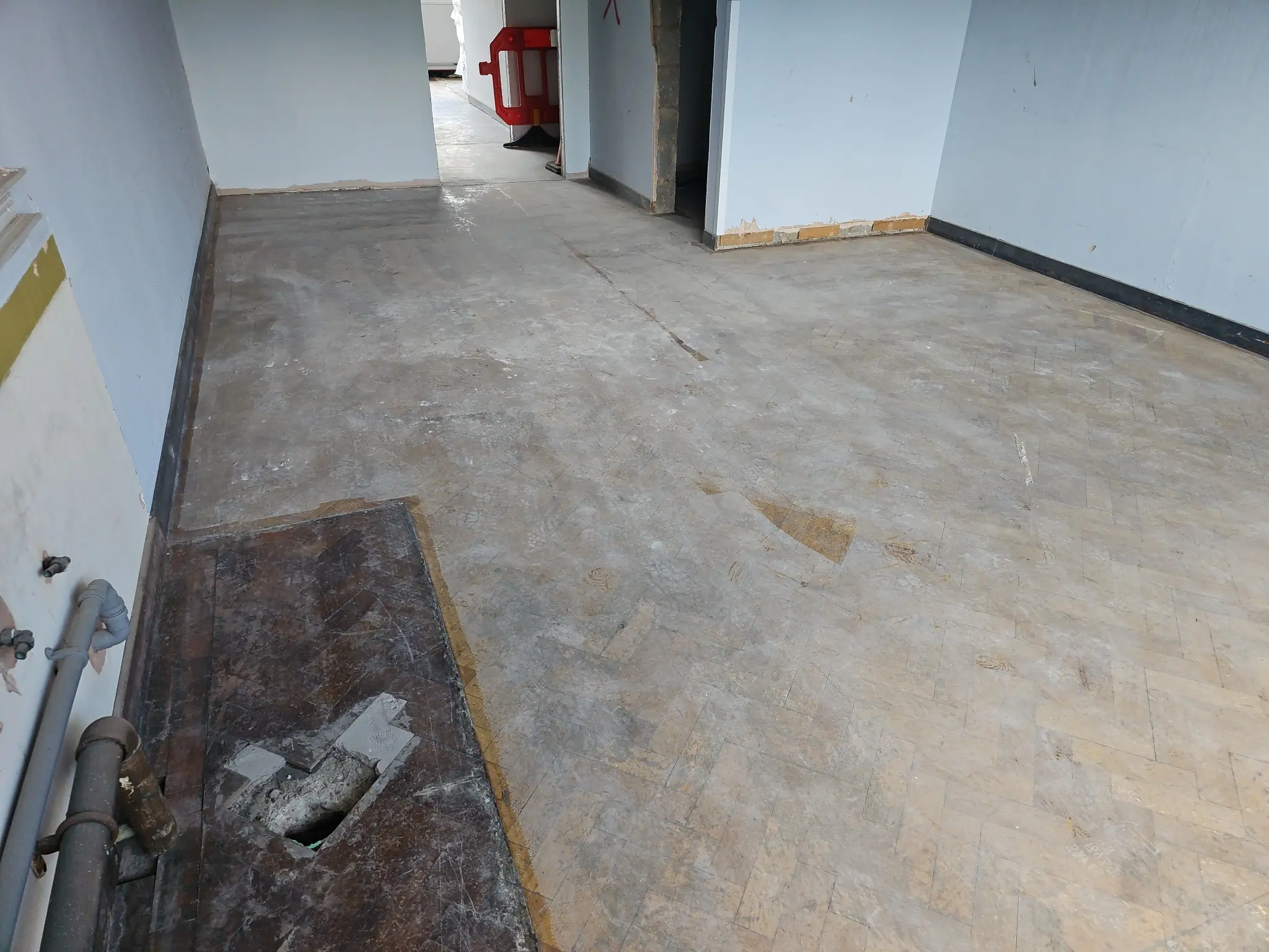 Worn school parquet floor before restoration